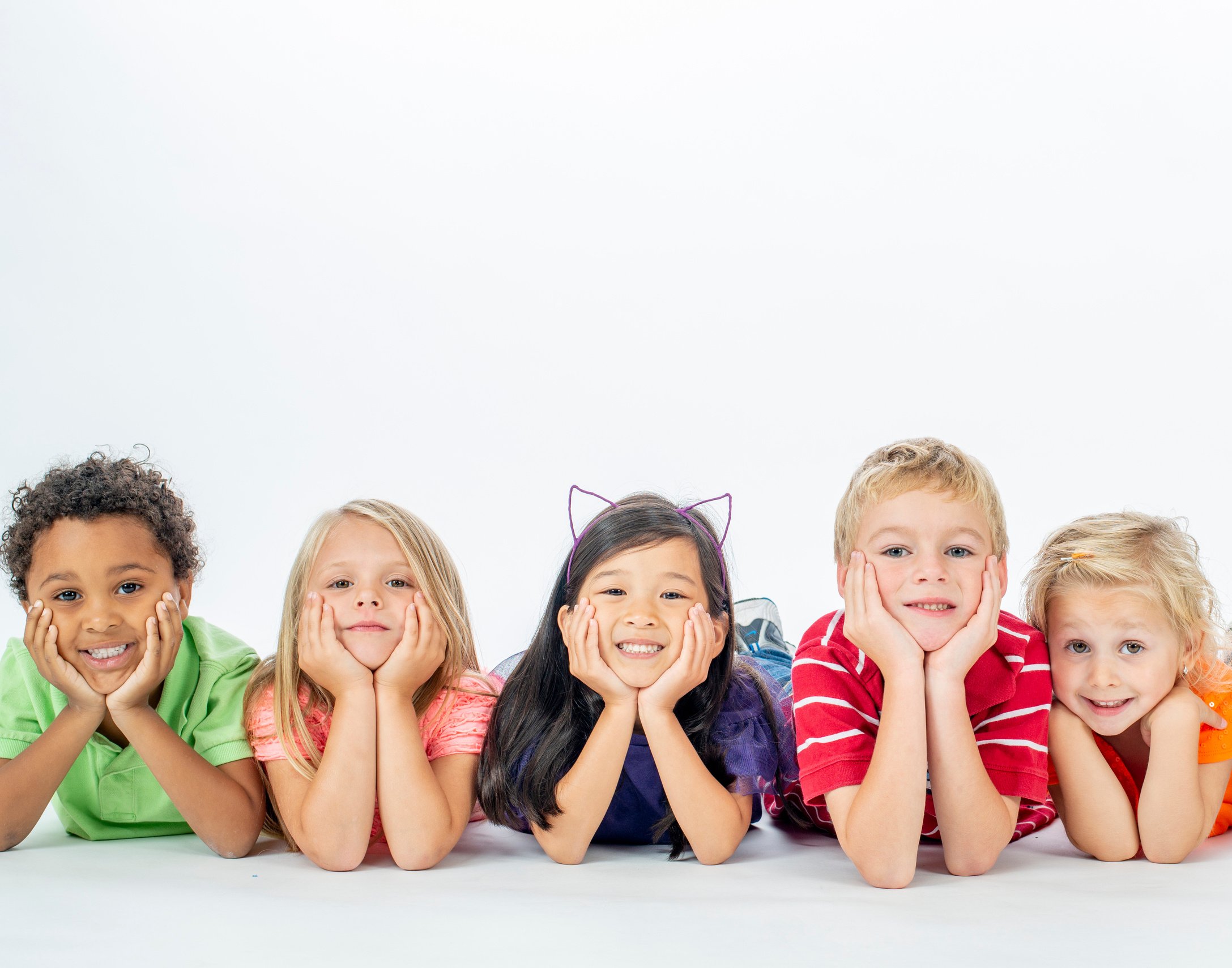 Happy Kids Laying in a Row Smiling